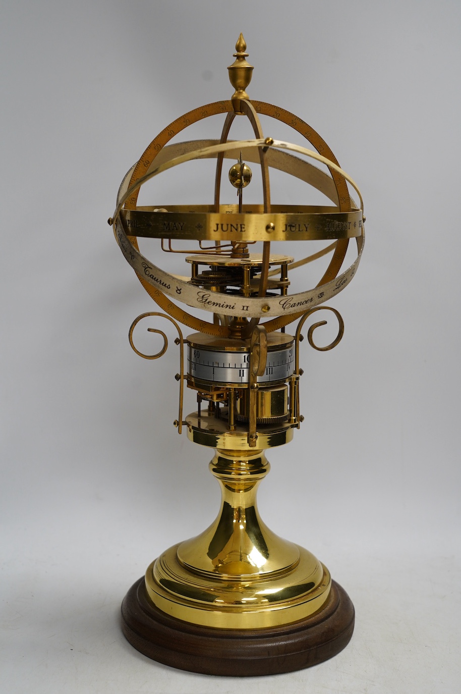 A modern clockwork armillary sphere, engraved St. James’s House Co. London, 44cm high, with two related books. Condition - fair, some discolouration to the metal work and general wear.